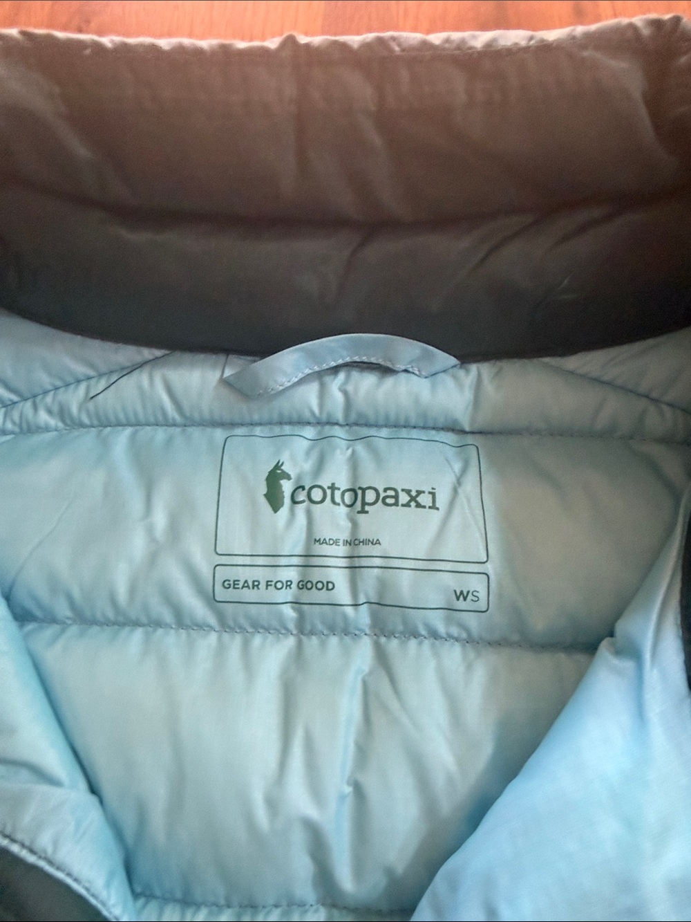 Cotopaxi Teal Puffer Vest with Yellow & Light Blue Stripes - Picture 2 of 4